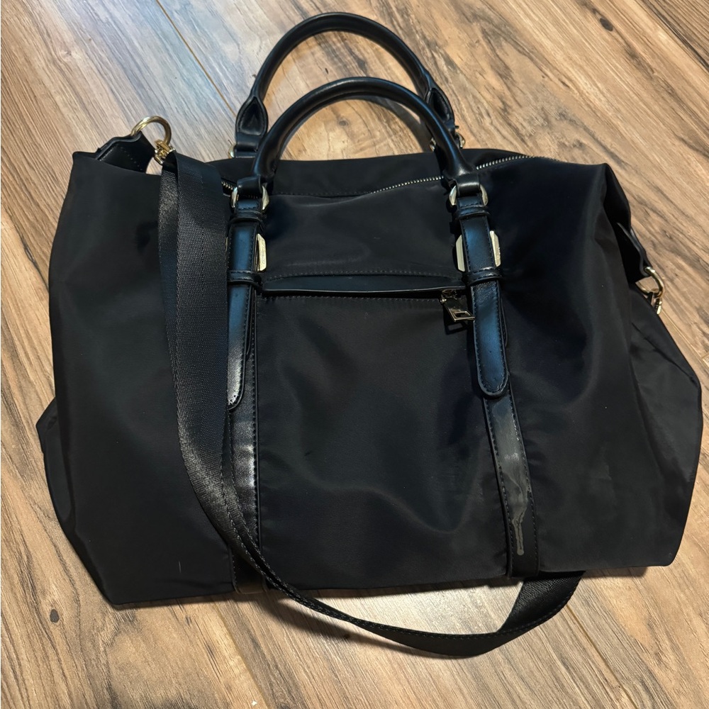 Black Travel Bag with Leather Trim and Versatile Straps